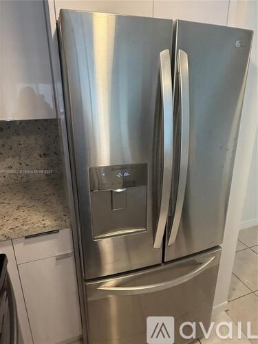 A stainless steel refrigerator with the Avail logo on the bottom right.