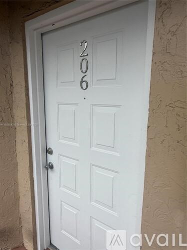 A white door with the number 206 on it.
