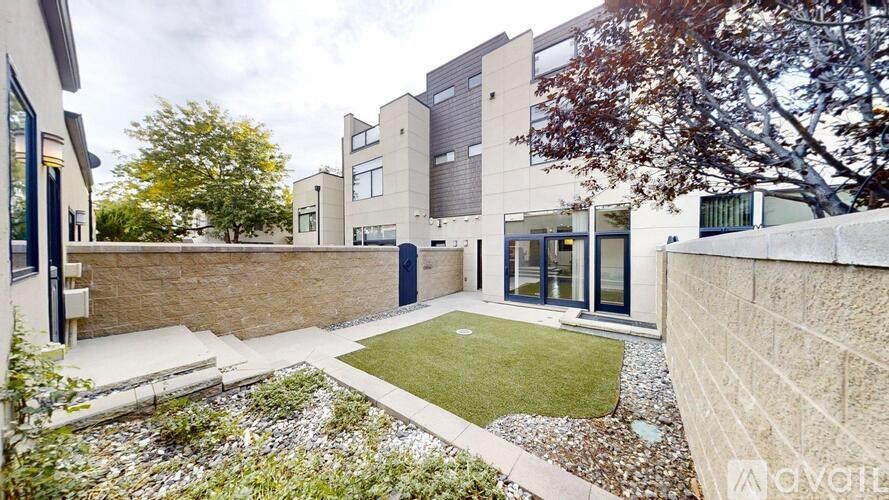 A modern house with a small garden in front.