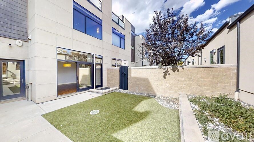 A modern building with a green lawn in front.