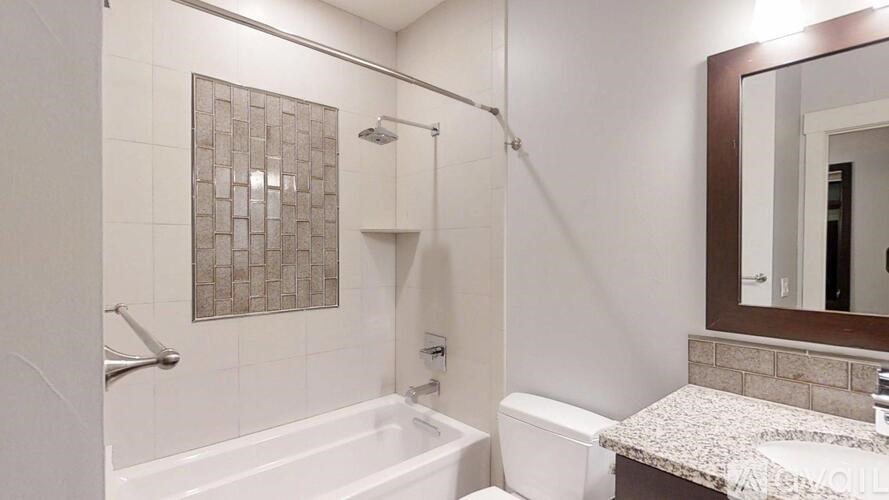 A white bathroom with a shower, toilet, and sink.