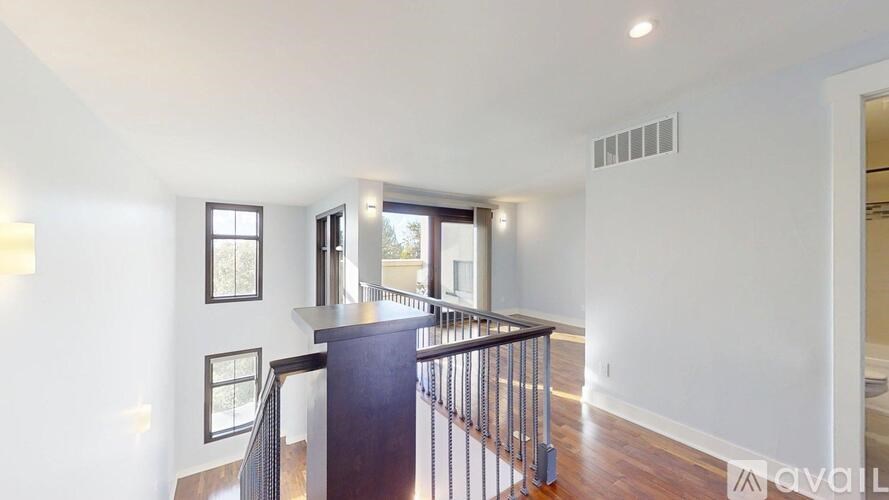 A spacious living room with a staircase leading to the upper floor.