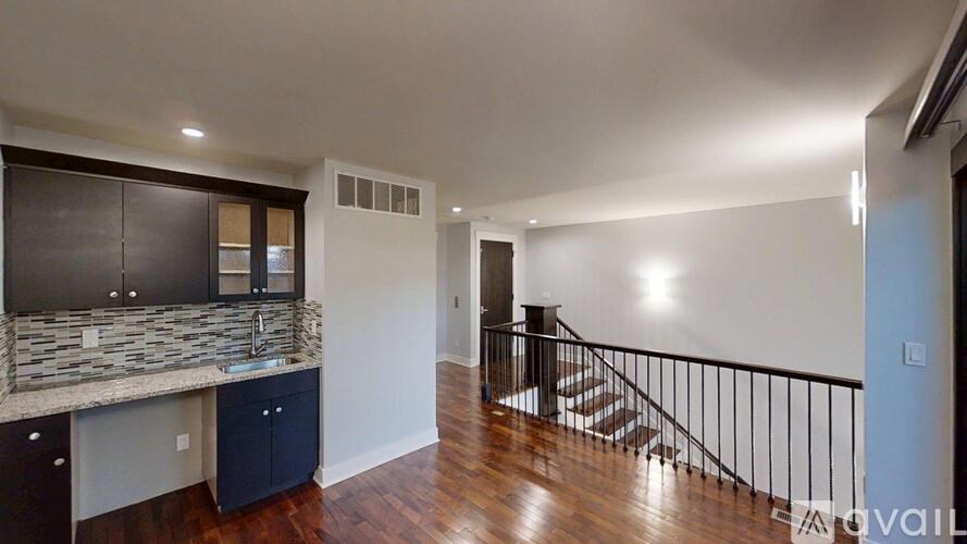 A spacious room with a staircase leading to the upper floor.