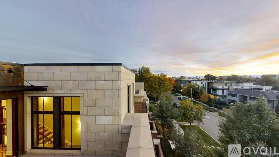 A modern house with a balcony and glass doors is available for rent.