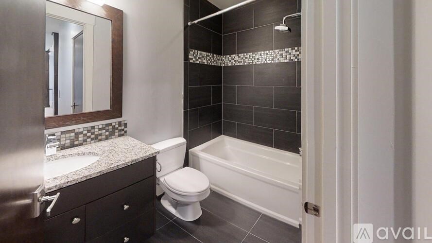 A bathroom with a toilet, sink, and shower.
