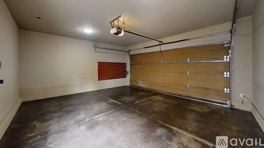 A room with a wooden slat wall and a pipe running along the wall.