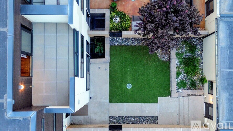 A modern house with a small garden and a pool.
