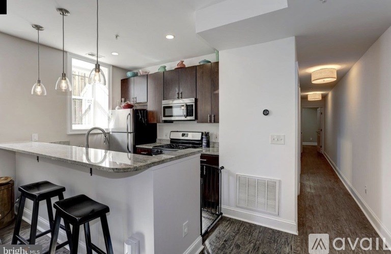 A kitchen with a bar area and a dining table.