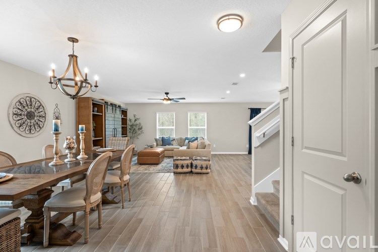 A dining room with a wooden table and chairs.