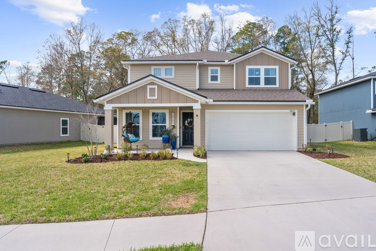 A house with a garage and a driveway is available for sale.