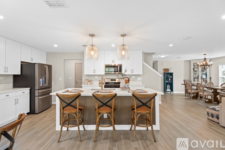 A modern kitchen with a dining table set for four.