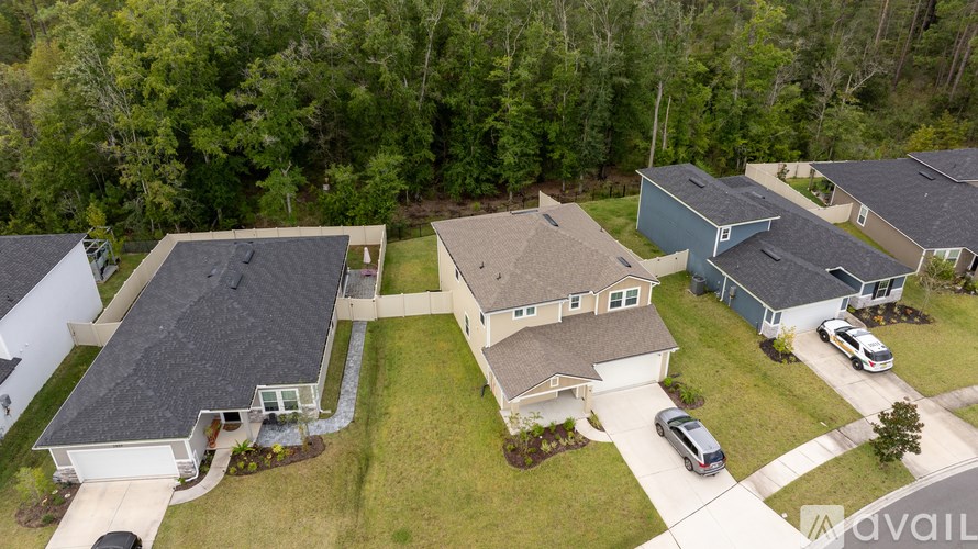 A bird's eye view of a residential area with houses and cars.
