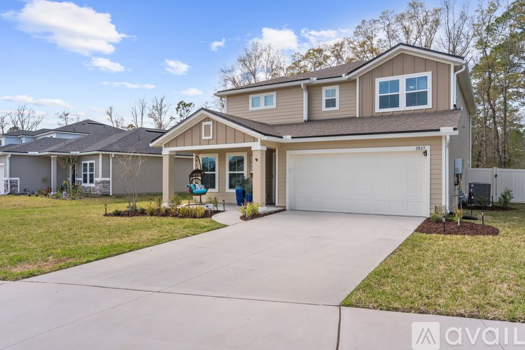 A house with a garage and a driveway is available for sale.