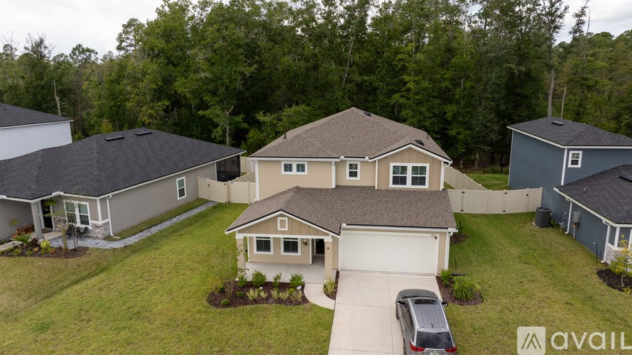 A house with a car parked in front of it.