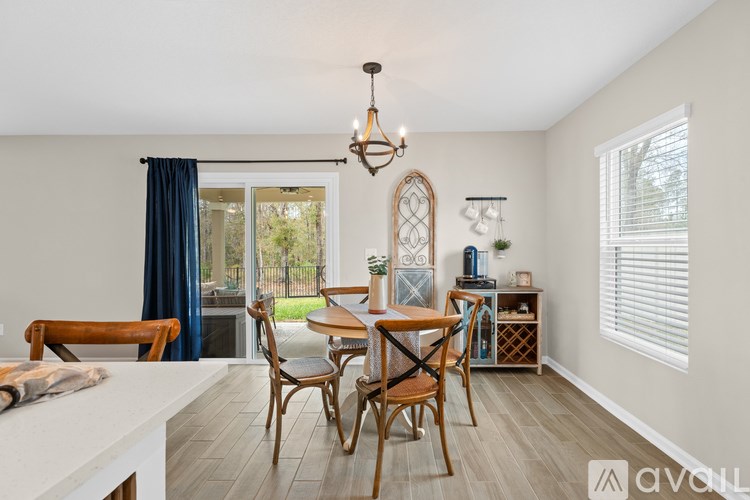 A dining room with a wooden table and chairs.