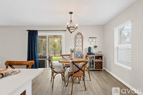 A dining room with a wooden table and chairs.