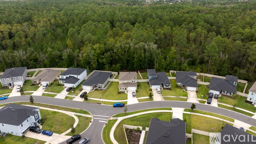 A bird's eye view of a residential area with houses and cars.