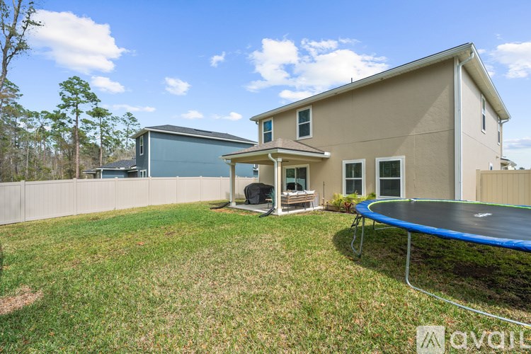 A house with a trampoline in the backyard.