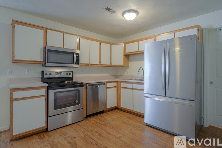 A kitchen with wooden cabinets and stainless steel appliances.