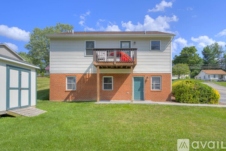 A two-story house with a balcony on the second floor.