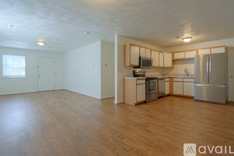 A kitchen with wooden floors and stainless steel appliances.