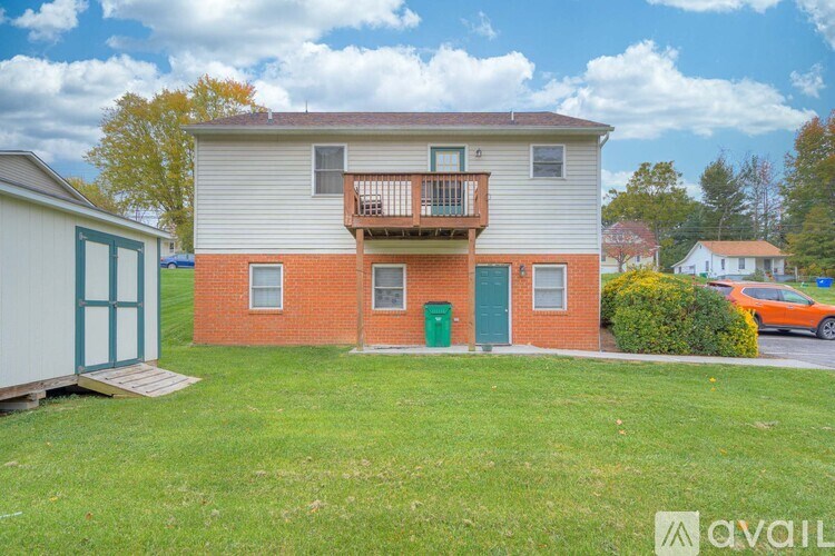 A two-story building with a balcony on the second floor.