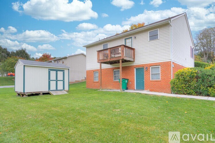 A house with a trailer in the yard.