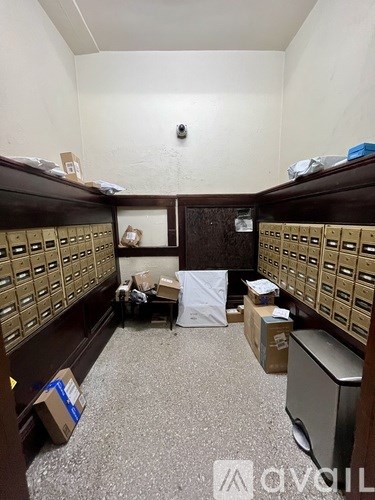 A room with a lot of boxes and a computer.