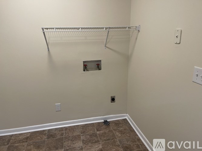A room with a shelf and a tile floor.