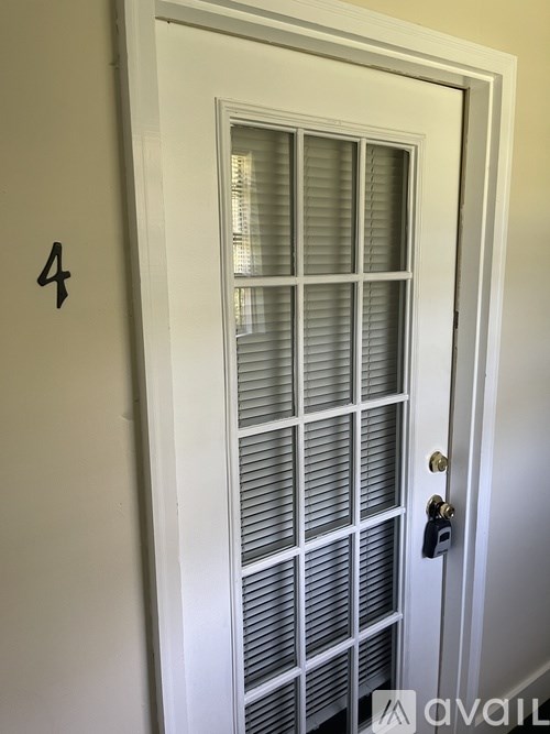 A white door with a number 4 on the wall next to it.