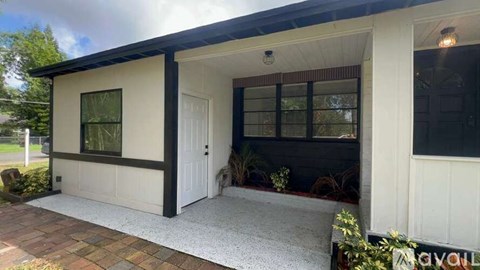 A house with a white exterior and a black roof.