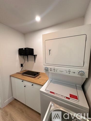 A small laundry room with a washer and dryer.