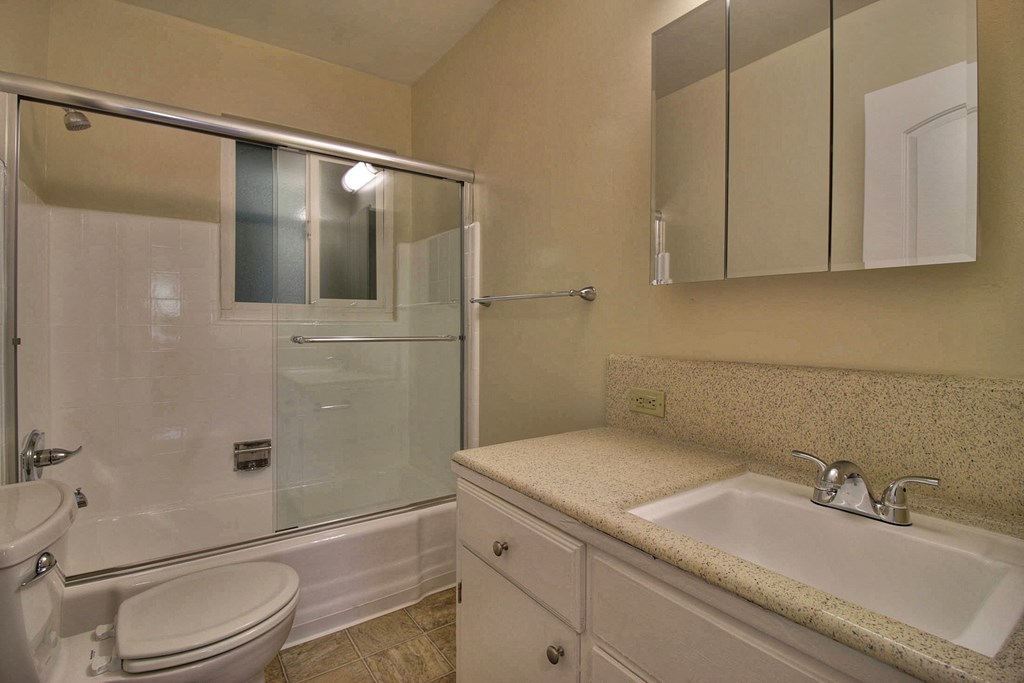 a bathroom with a sink toilet and a shower