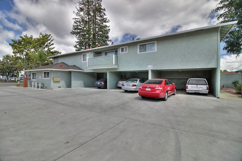 a large parking lot with cars in front of a building