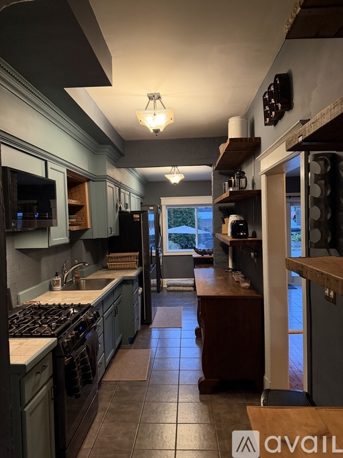 A kitchen with a stove top oven and a counter top.