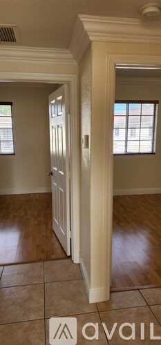 A room with a wooden floor and a white door.