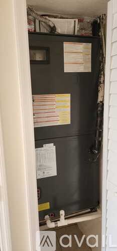 A black fridge with a white door is open.