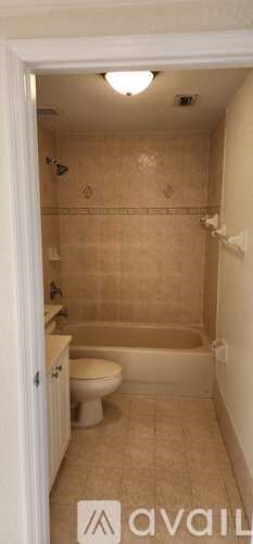 A bathroom with a toilet, tub, and shower.