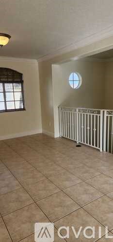 A room with a window and a radiator on the floor.