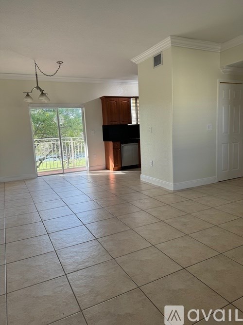 A living room with a television and a sliding glass door.