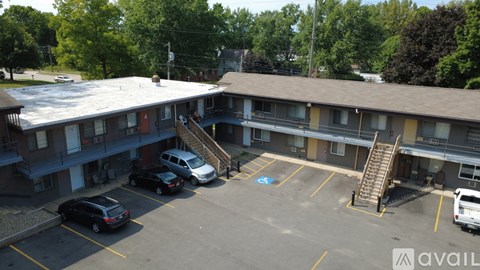 A parking lot with a white van and a black car.