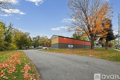 An aerial view of a large building surrounded by trees and a parking lot.