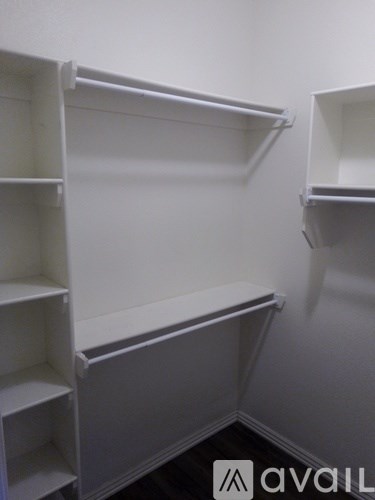 Empty white shelves in a room.