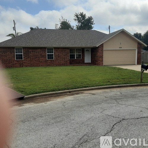 A house with a garage and a driveway in front.