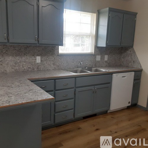 A kitchen with a sink and cabinets.