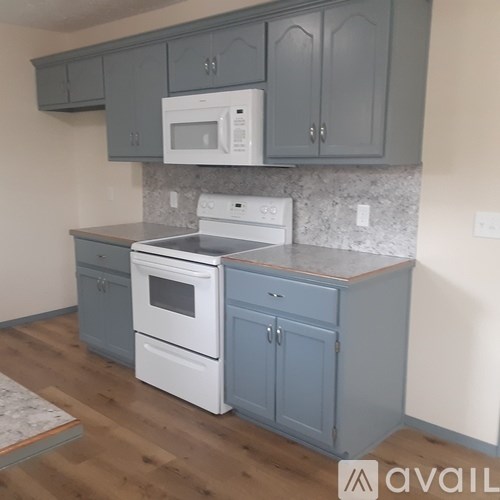A kitchen with a white oven and microwave above a white stove.