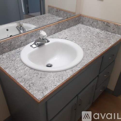 A bathroom sink with a granite counter top.
