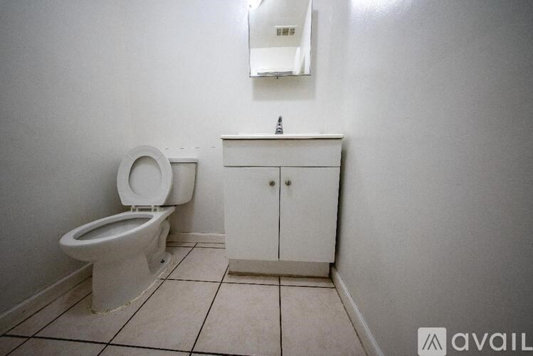 A white toilet and cabinet in a bathroom.