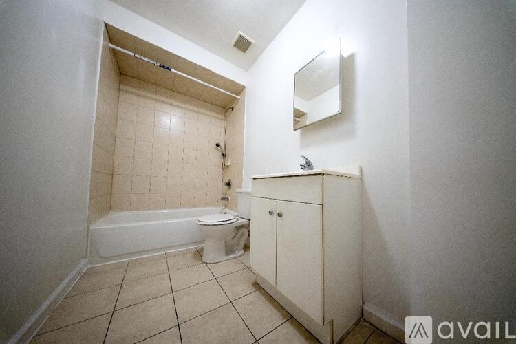 A bathroom with a toilet, sink, and bathtub.