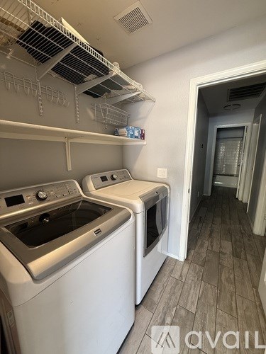 A kitchen with a washing machine and dryer in it.